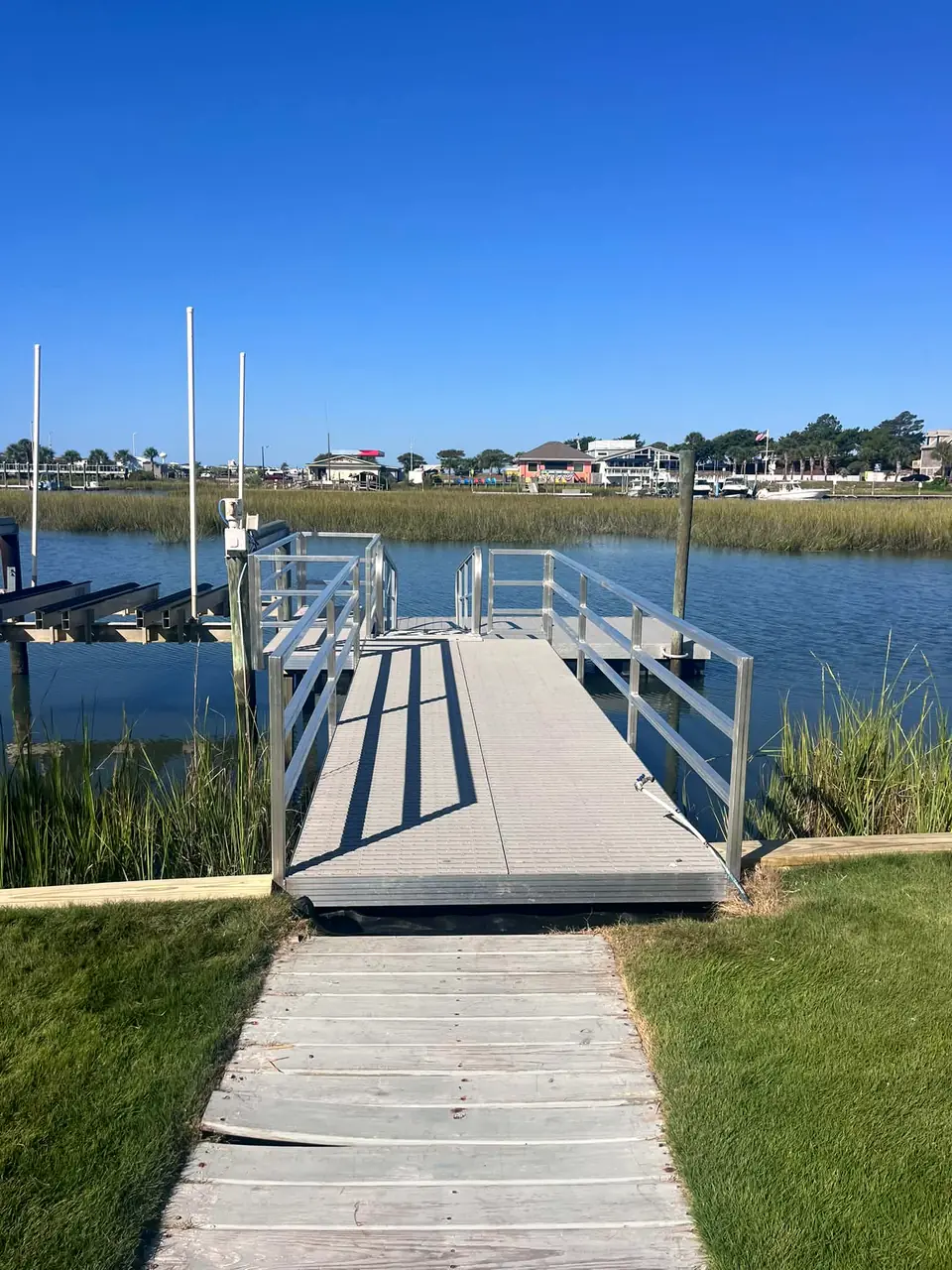 After: new aluminum gangway with composite decking leading to the water