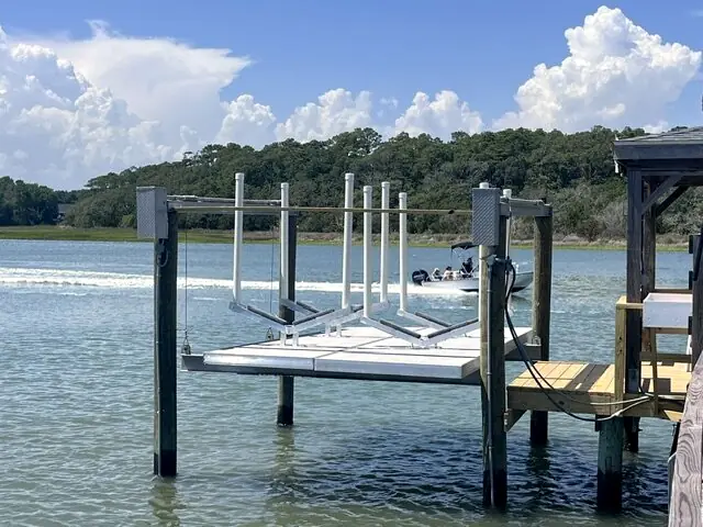 Boat lift with custom jet ski platforms on an open waterway