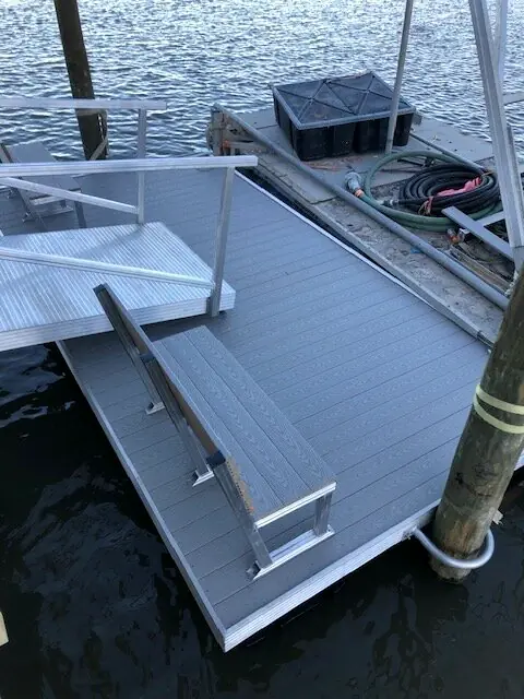 Aluminum floating dock with a bench and gangway landing