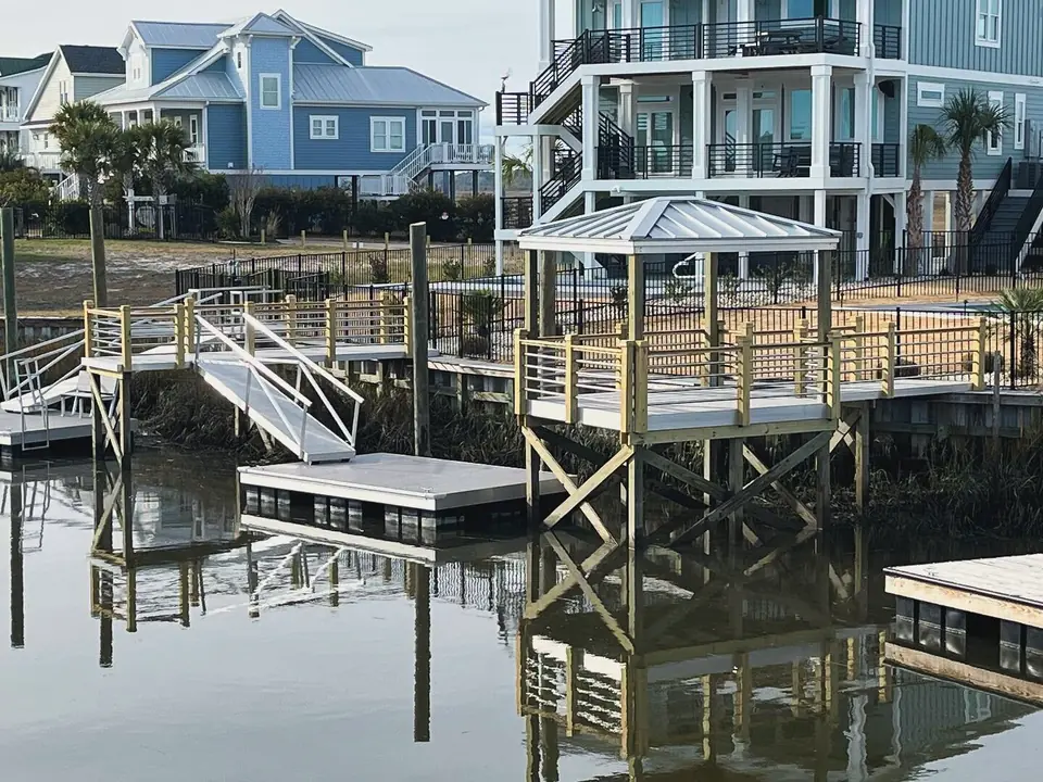 Elevated pier with a gazebo, aluminum gangway and floating dock behind a canal-front home