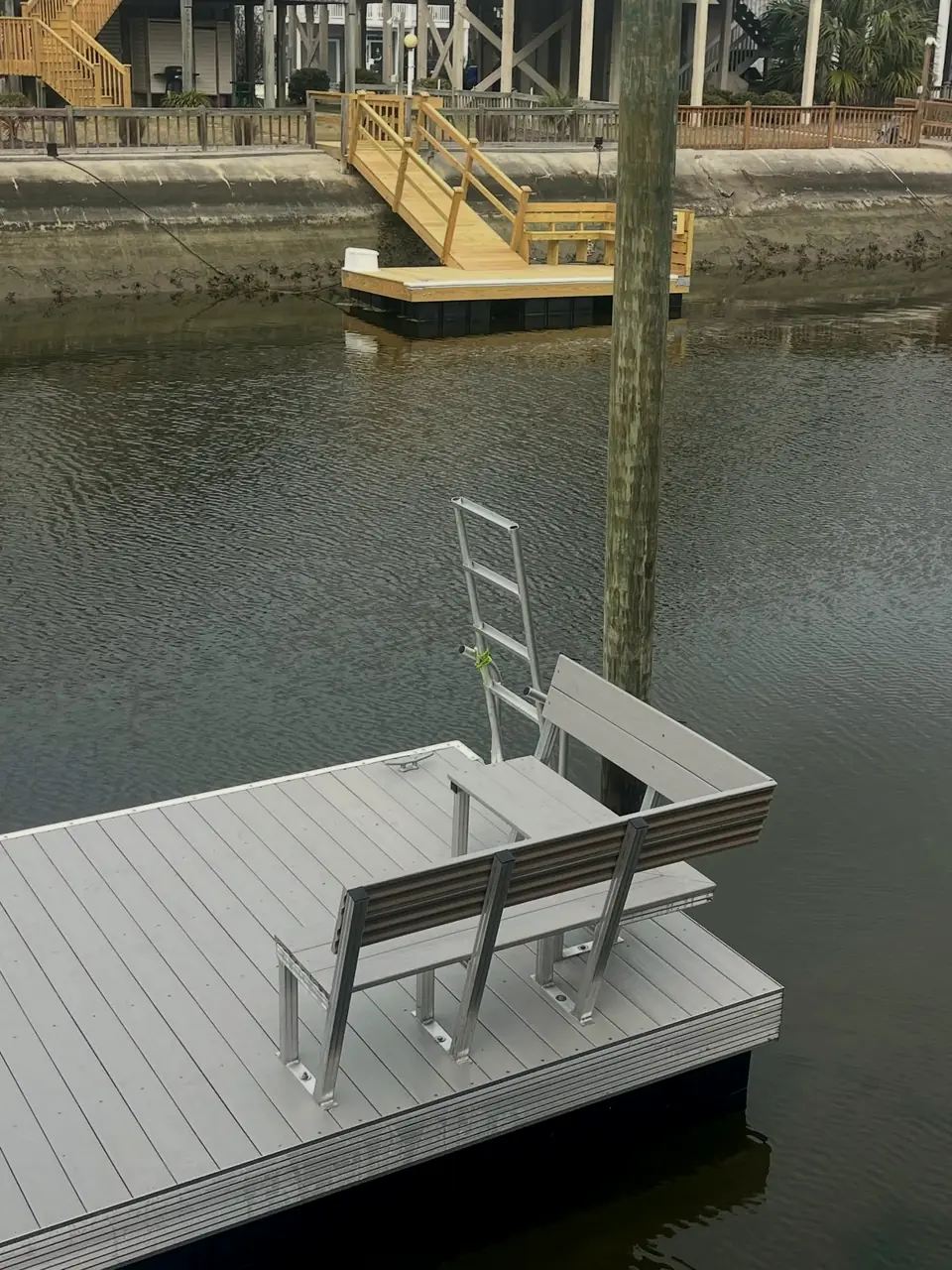 Aluminum bench mounted on a floating dock