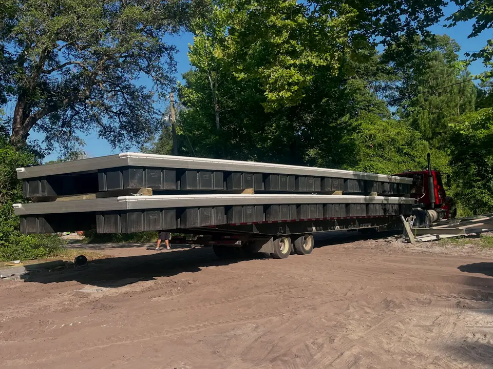 Two 12 by 48 foot aluminum docks loaded on a trailer for delivery